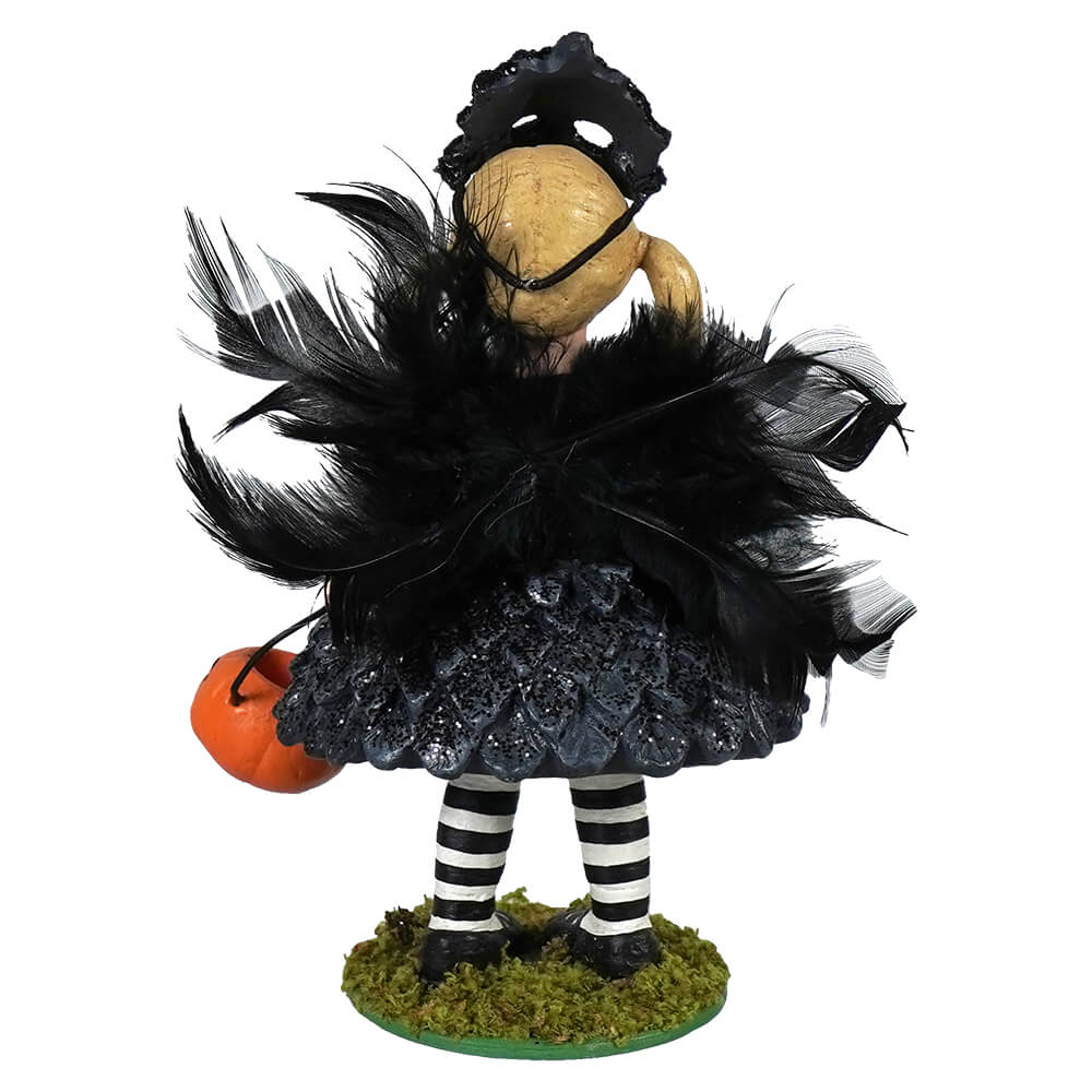 Black feathered crow hazel girl witch figurine with black lace mask glittery skirt striped legs holding orange pumpkin