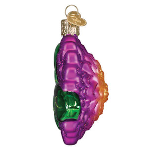 A vibrant dahlia ornament made of iridescent glass in purple green and orange hues shaped like a seashell christmas glass ornament