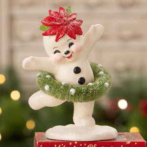 A cheerful white dancing snowman girl figurine by bethany lowe design holding a green garland wreath in ballet pose