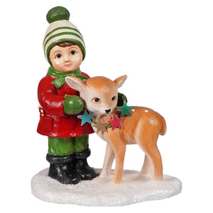 A charming bethany lowe designs figurine of a child in red coat holding a colorful star-decorated deer