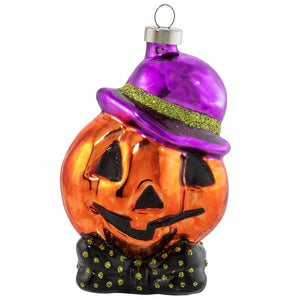 A glossy orange glass dapper jack ornament wearing a purple hat with green glitter trim and black polka-dotted bow tie perfect as a candy ornament