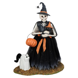Deadra skeleton figurine dressed in black gown with orange ribbon holding pumpkin basket and black cat with witch hat