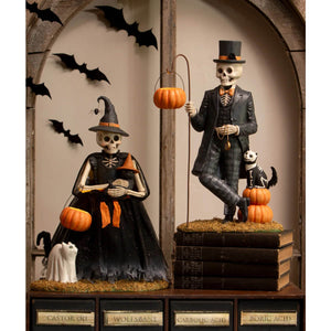 Deadra skeleton halloween figurine set featuring a dressed male and female skeleton in formal attire with orange accents