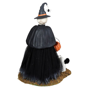Black witch figurine wearing tall pointed hat and tulle skirt holding orange pumpkin basket deadra skeleton product
