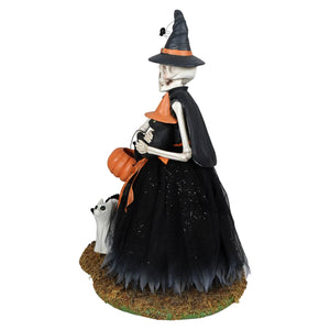 Deadra skeleton figurine wearing black and orange costume with glittery tulle skirt holding pumpkin bucket