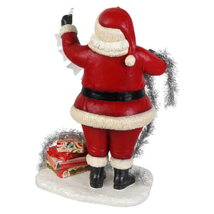 Deck the halls santa figurine by bethany lowe designs in red and white holding silver tinsel waving black boots folk art santa