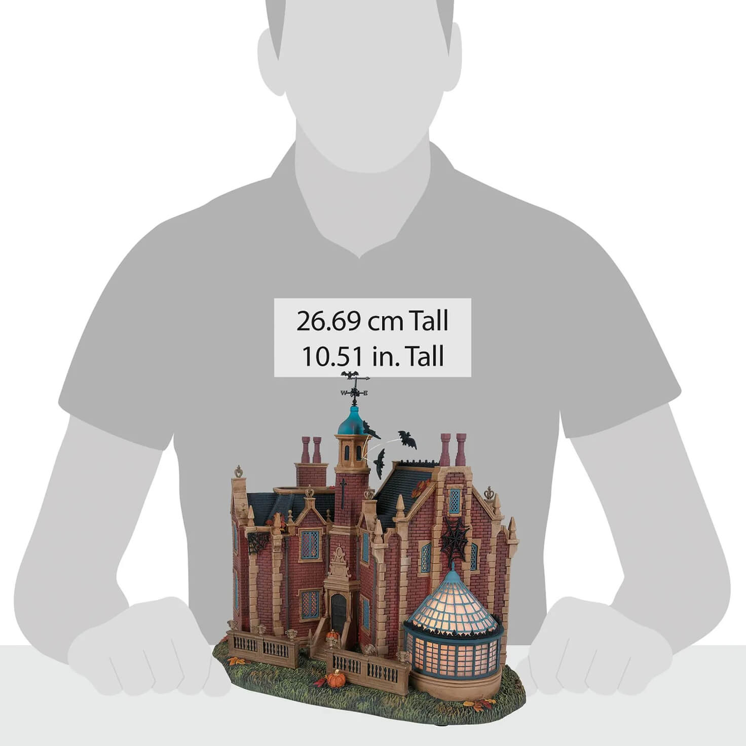 Detailed disney haunted mansion miniature with red brick walls blue tower black slate roof and pumpkins for disney world fans