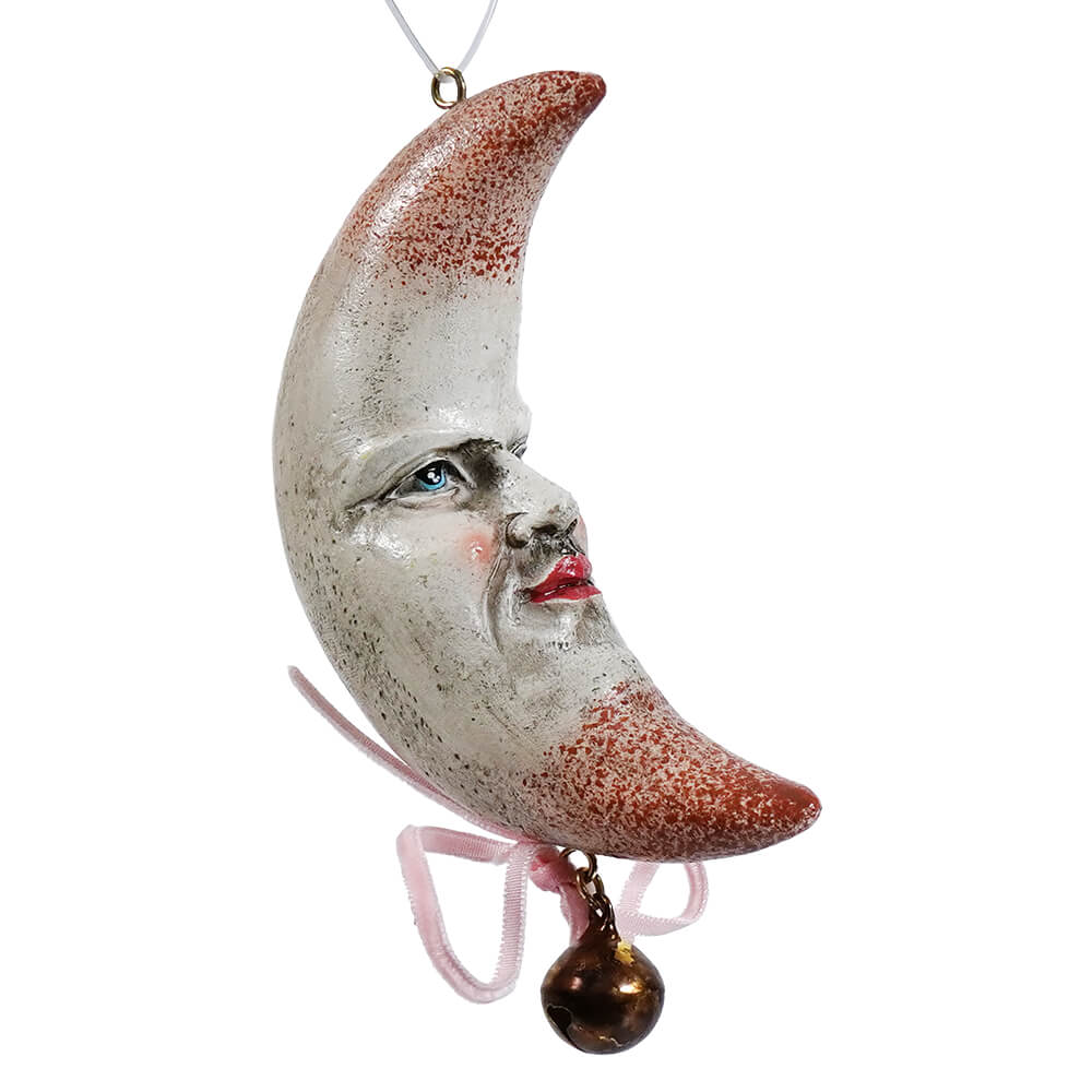 Whimsical resin half moon ornament with painted face silver reddish brown glaze and pink ribbon bell for celestial decor