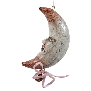 Whimsical resin half moon ornament with painted face silver rust finish and pink ribbon perfect for celestial decor