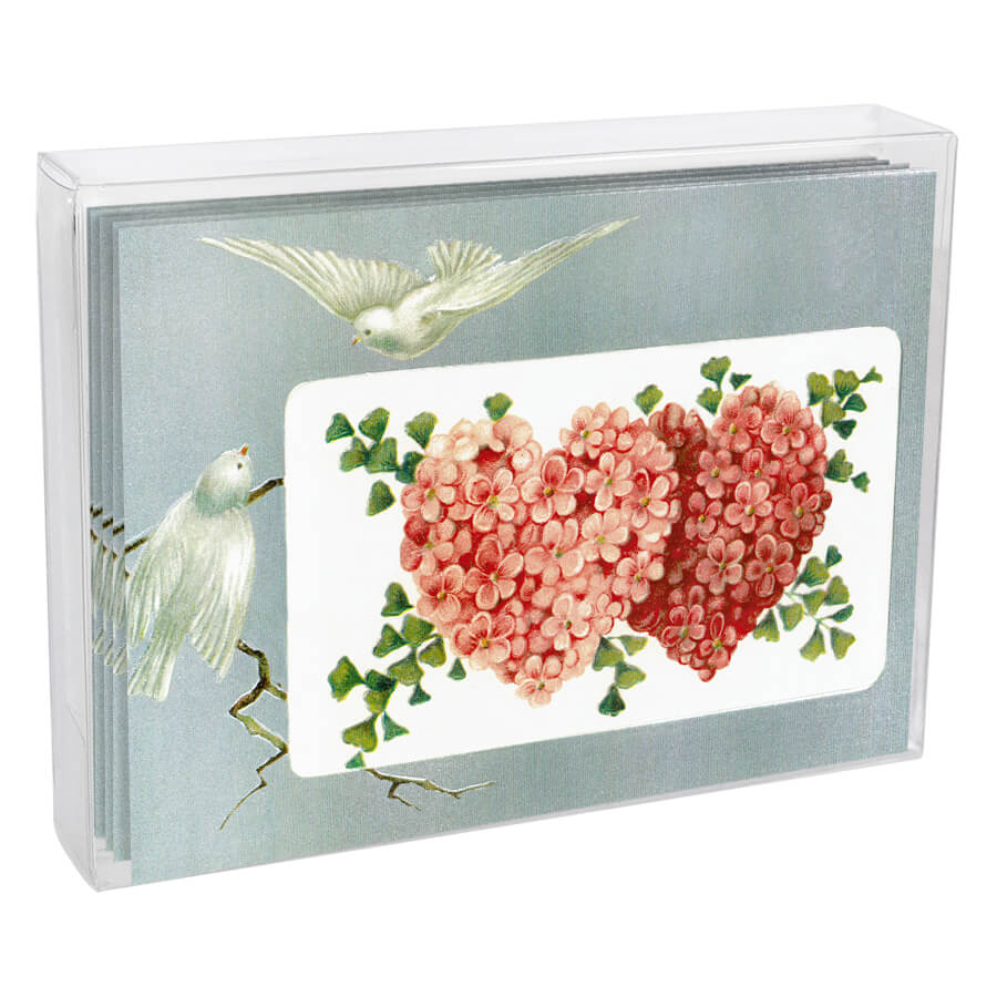 Decorative shadow box featuring two floral hearts and dove designs.