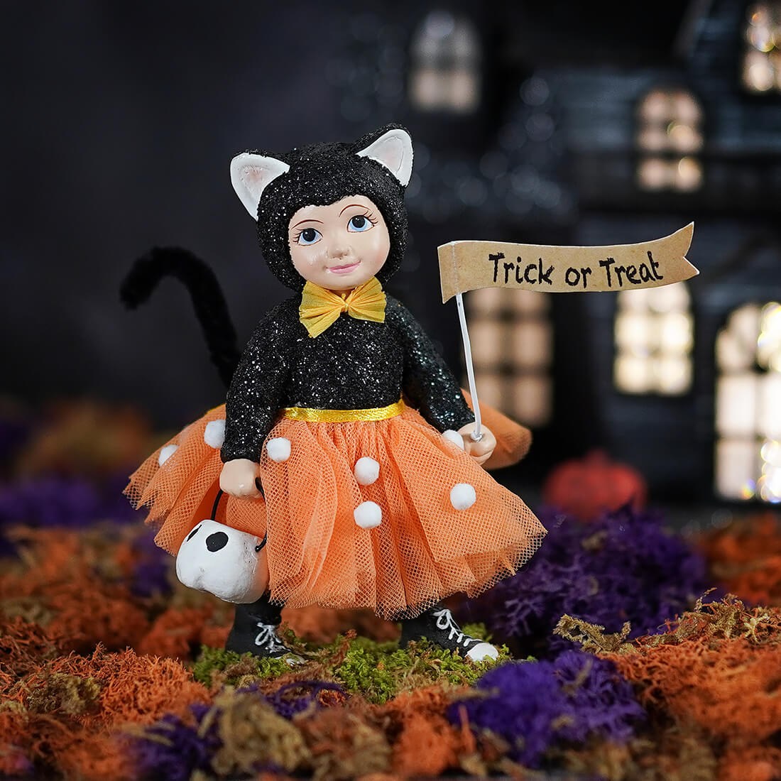 Dressed up rorie black glittery cat doll with white ears yellow bow orange polka-dot tutu holding trick or treat sign bethany lowe halloween figures and dolls