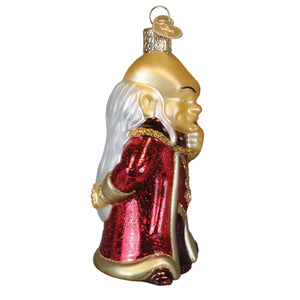 A golden glass dungeons and dragons dungeon master ornament with long white hair and a glittery red robe, perfect tabletop decor