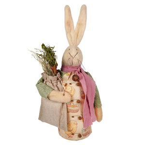 A plush attire white bunny holding sack of hay wearing a patterned apron and pink scarf vintage easter bunny figural decor