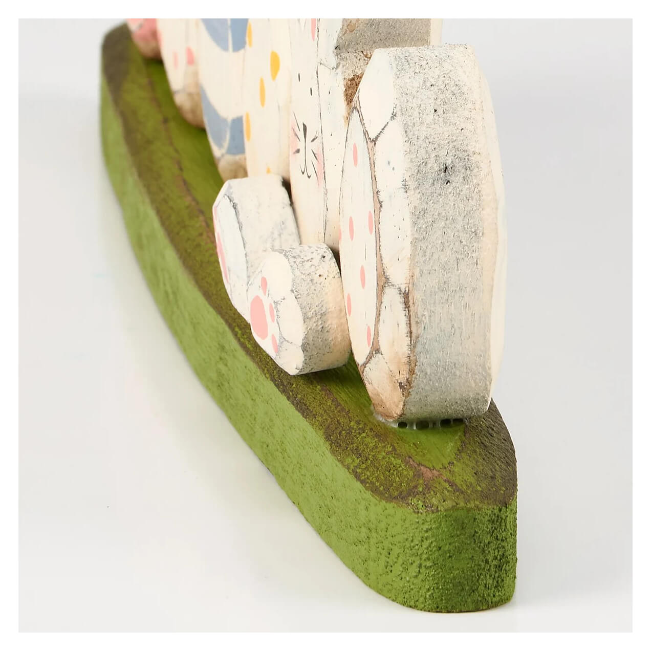 A charming wooden easter bunny tabletop decor with distressed white finish pink polka dots on green base