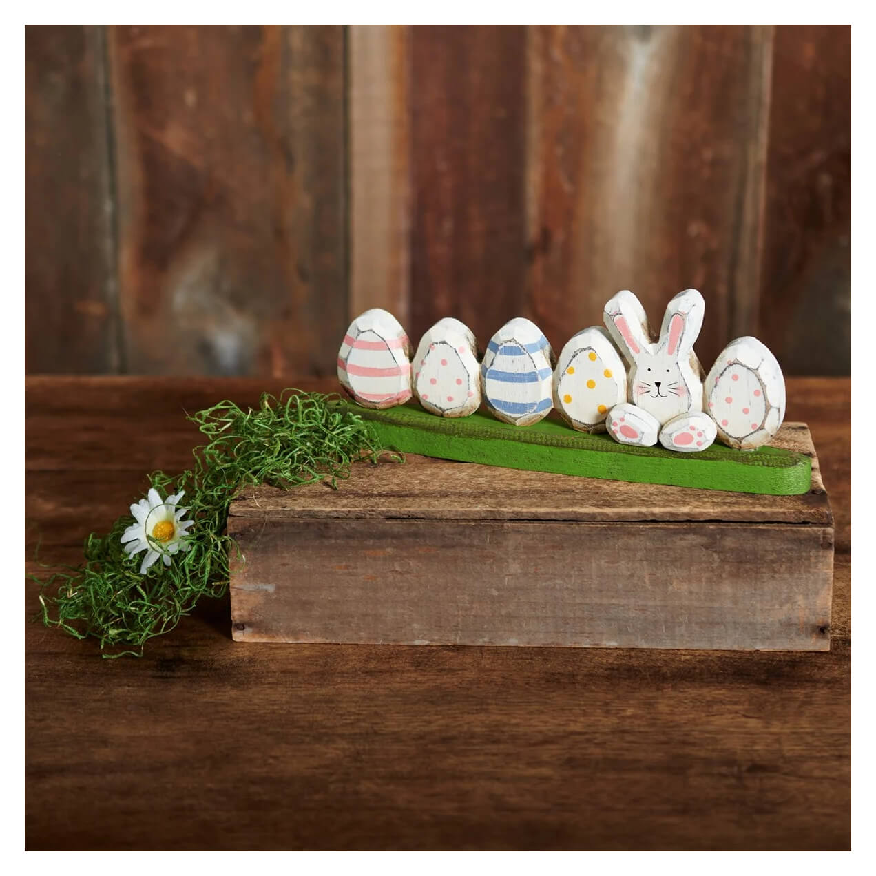 A charming wooden easter bunny tabletop decor with five painted eggs on a green grassy base perfect for spring display