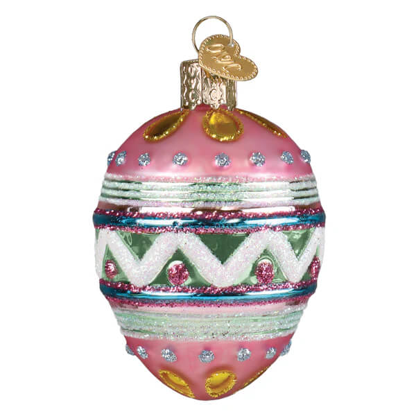 A pink hand-painted resin easter egg ornament with glittery green white zigzags gold accents and rhinestones