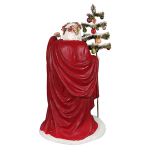 Red resin santa figurine holding a miniature decorated christmas tree from elegant lighting the way santa folk art santas