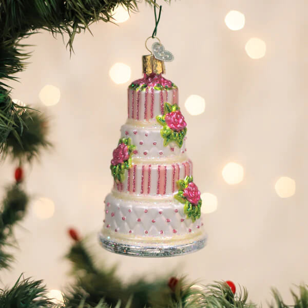 Elegant wedding cake ornament with pink and white frosting, glittery stripes, floral details on silver base christmas glass ornament