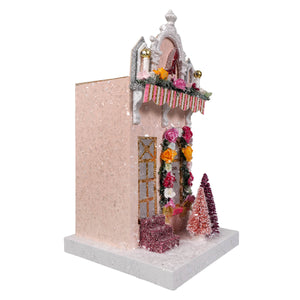 Pink glittery miniature ellen’s shoe shoppe with white ornate arch, floral garlands, frosted trees cody foster light cord