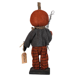 Decorative pumpkin-headed figure wearing a gray jacket and plaid pants, standing on a small base.