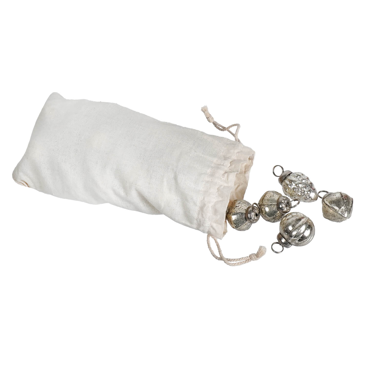 A white muslin bag set spilling embossed antique silver mercury glass ornaments with textured faceted surfaces