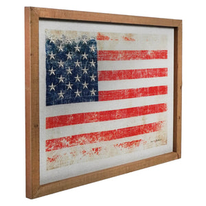 Distressed American flag artwork in a wooden frame.