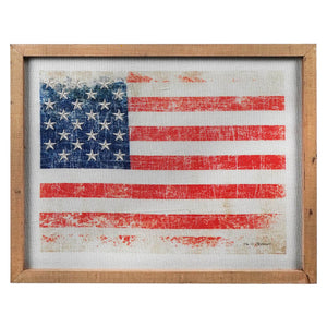 Distressed American flag in a wooden frame.