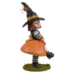 A detailed emery witch figurine with orange skirt black and white striped sleeves and a tall black hat with golden spider perfect for halloween witches decor