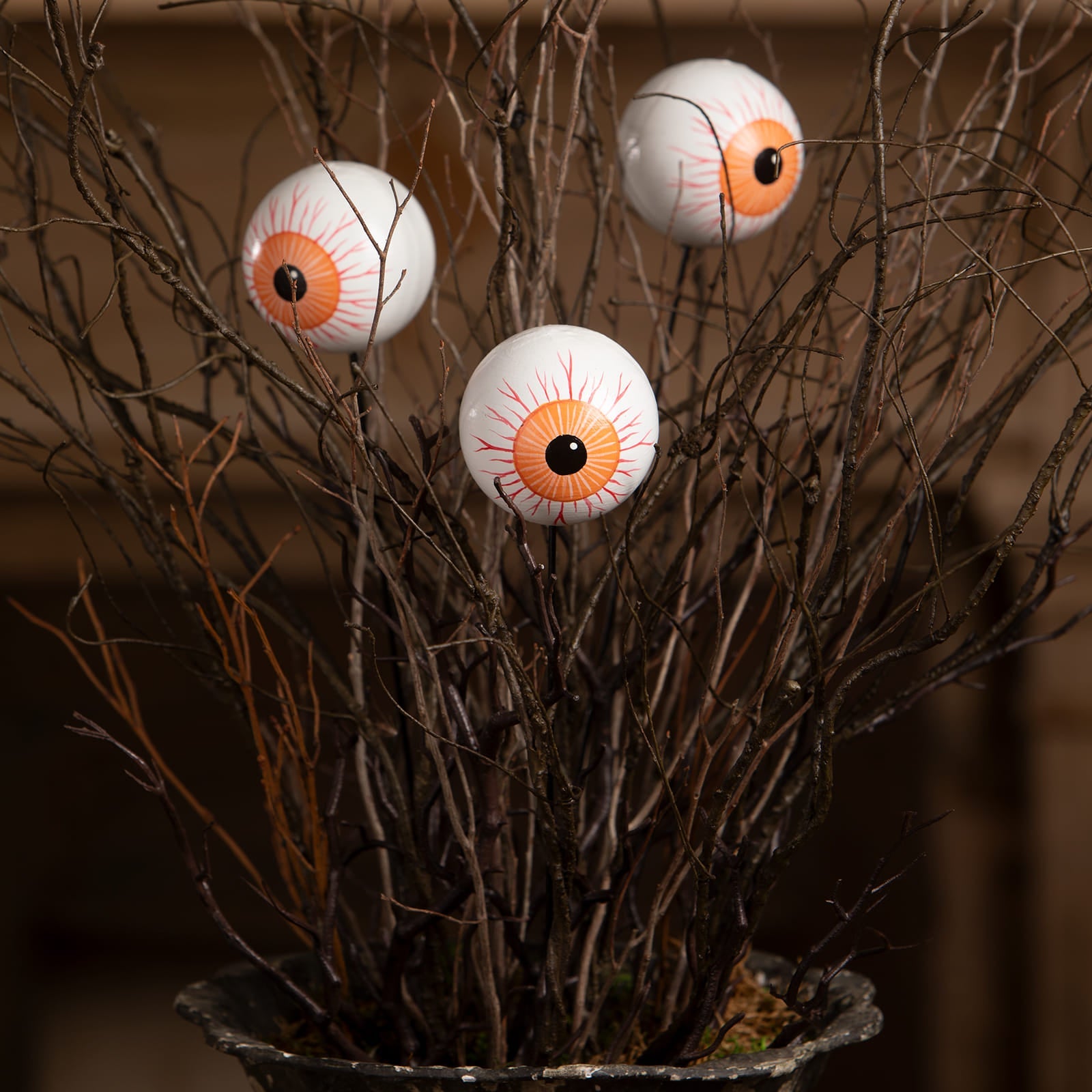 Three white plastic eyeball picks with orange irises and red veins from bethany lowe designs halloween garlands wreaths & picks