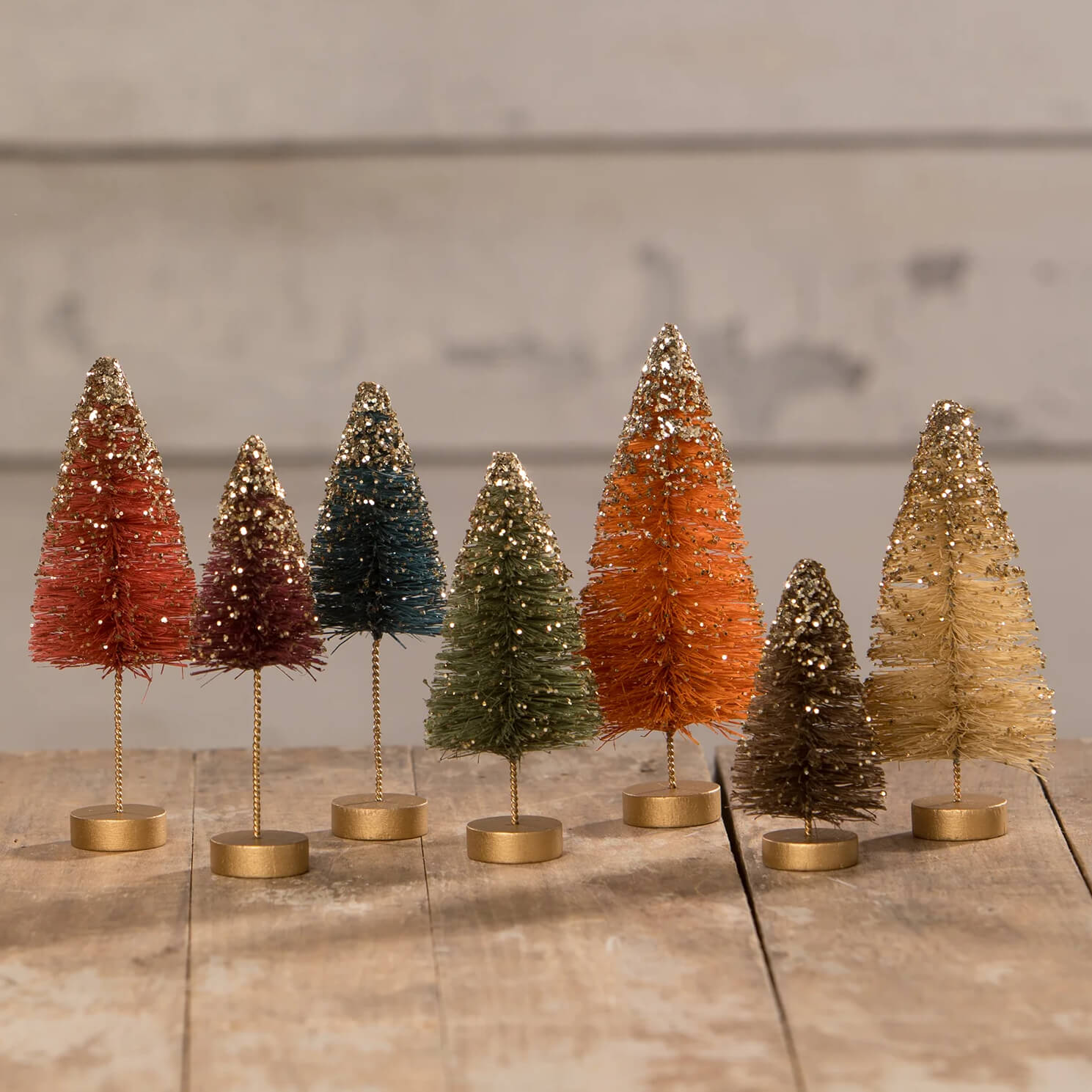 A fall bottle brush trees set of 7 glittery miniature village trees in warm hues on brass bases perfect for decor