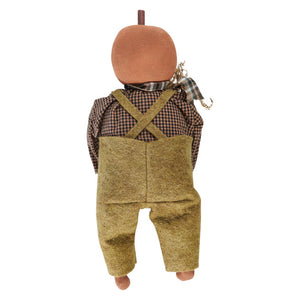 A rustic freddy pumpkin doll with a pumpkin head wearing olive green overalls from the kathy fall collection