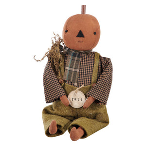Fall freddy pumpkin doll wearing green overalls and a plaid scarf from kathy fall collection perfect for autumn decor
