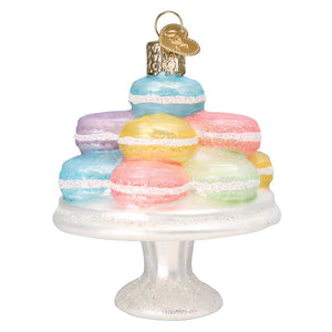Fancy macarons ornament featuring pastel yellow macaroon ornament figural decor on glittery lighted cake stand