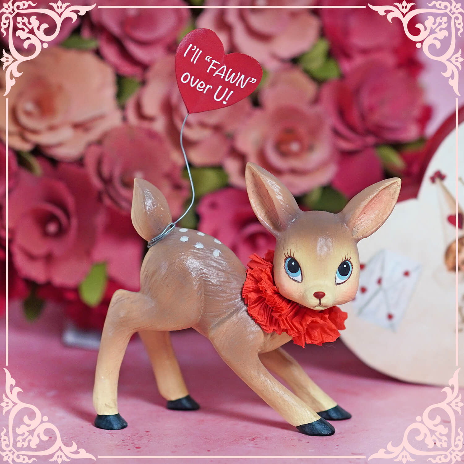 Decorative deer figurine wearing a red ruffle collar with a heart-shaped balloon attached.