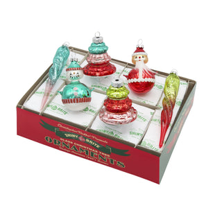 A set of colorful glass traditional shape ornaments with snowmen santa and trees in a festive red and green box