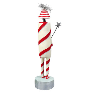 A whimsical firecracker character figurine with a red and white striped candy cane body and silver tinsel hat