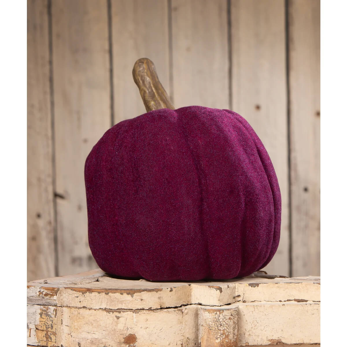 A bethany lowe design flocked purple jol plush pumpkin with textured fabric and a rustic wooden stem