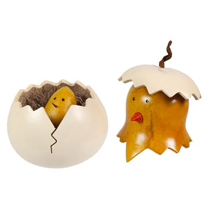 A charming yellow chick gourd figurine with a red beak and black eyes hatching from a cracked white eggshell