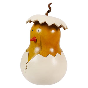 A charming hand carved chick gourd figurine with warm amber skin and glossy finish hatching from an egg with red beak
