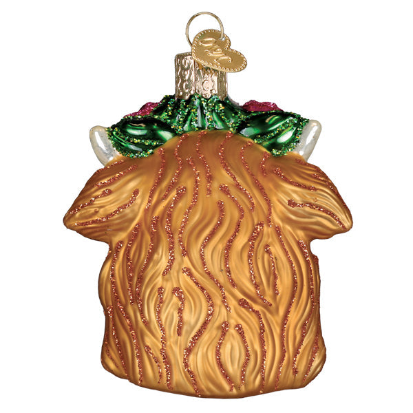 Golden glass highland cow ornament with textured fur and green glittery holly accents perfect for figural decor or lighted decor