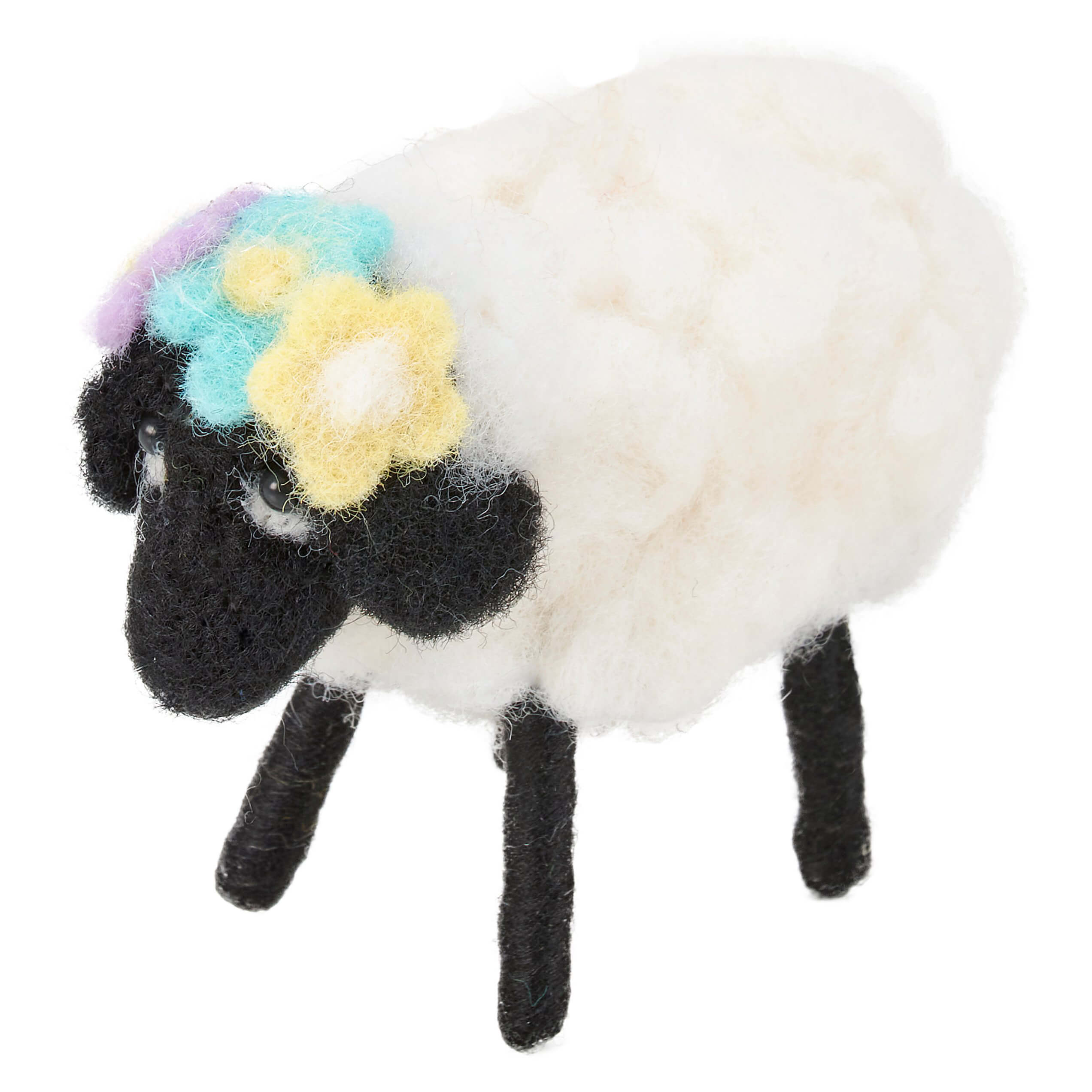 Decorative sheep with a white wool body, black legs and face, and colorful flowers on its head.