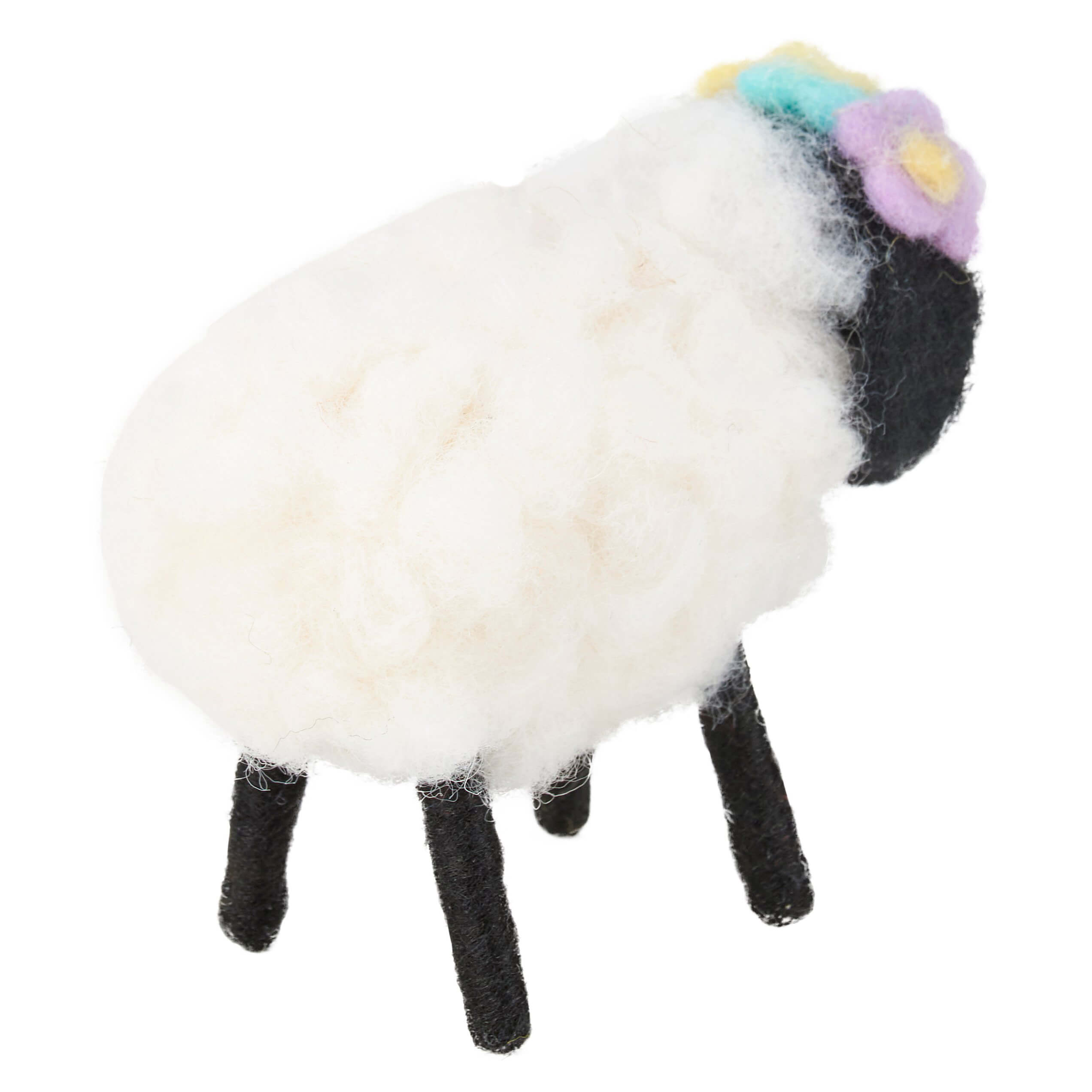 White fluffy sheep with black legs and a colorful flower on its head.