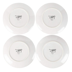 White ceramic flower bunnies stoneware plates with glossy finish and black cursive lisa audit branding underside view