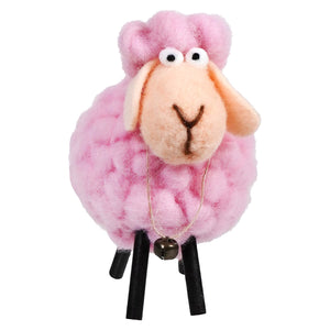 Pink fluffy sheep toy with black stick legs and googly eyes.