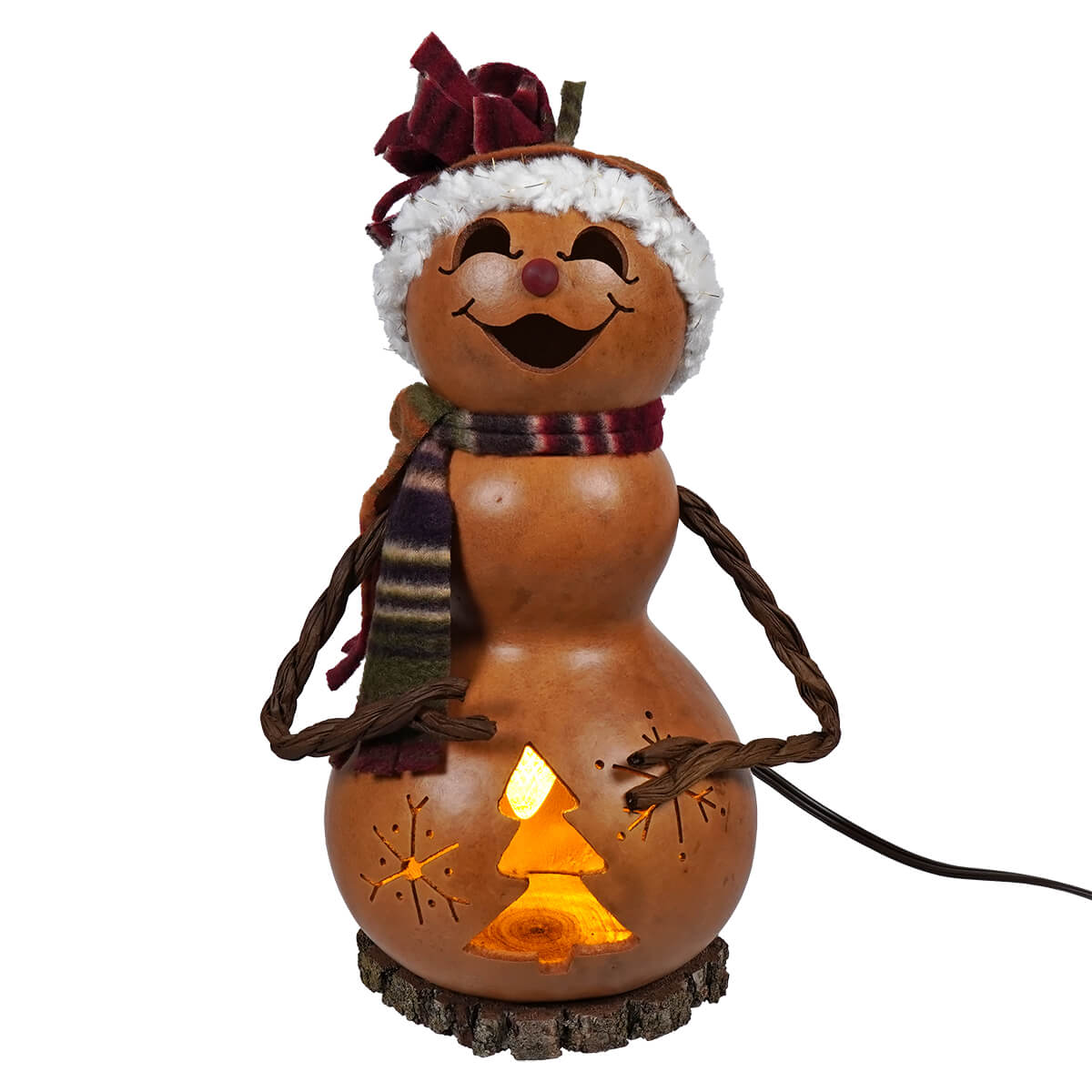 A lighted small tall brown snowman girl gourd from meadowbrooke gourds glowing warmly with carved tree and star design