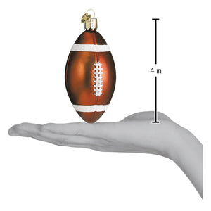A glossy amber glass football ornament with white laces and gold loop perfect for figural decor and glass & glitter collections
