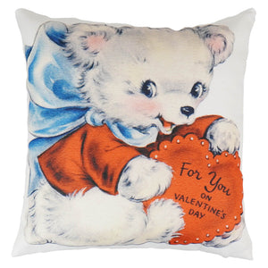 White valentines day pillow with a nicely woven vintage teddy bear in orange holding a heart spreading holiday cheer