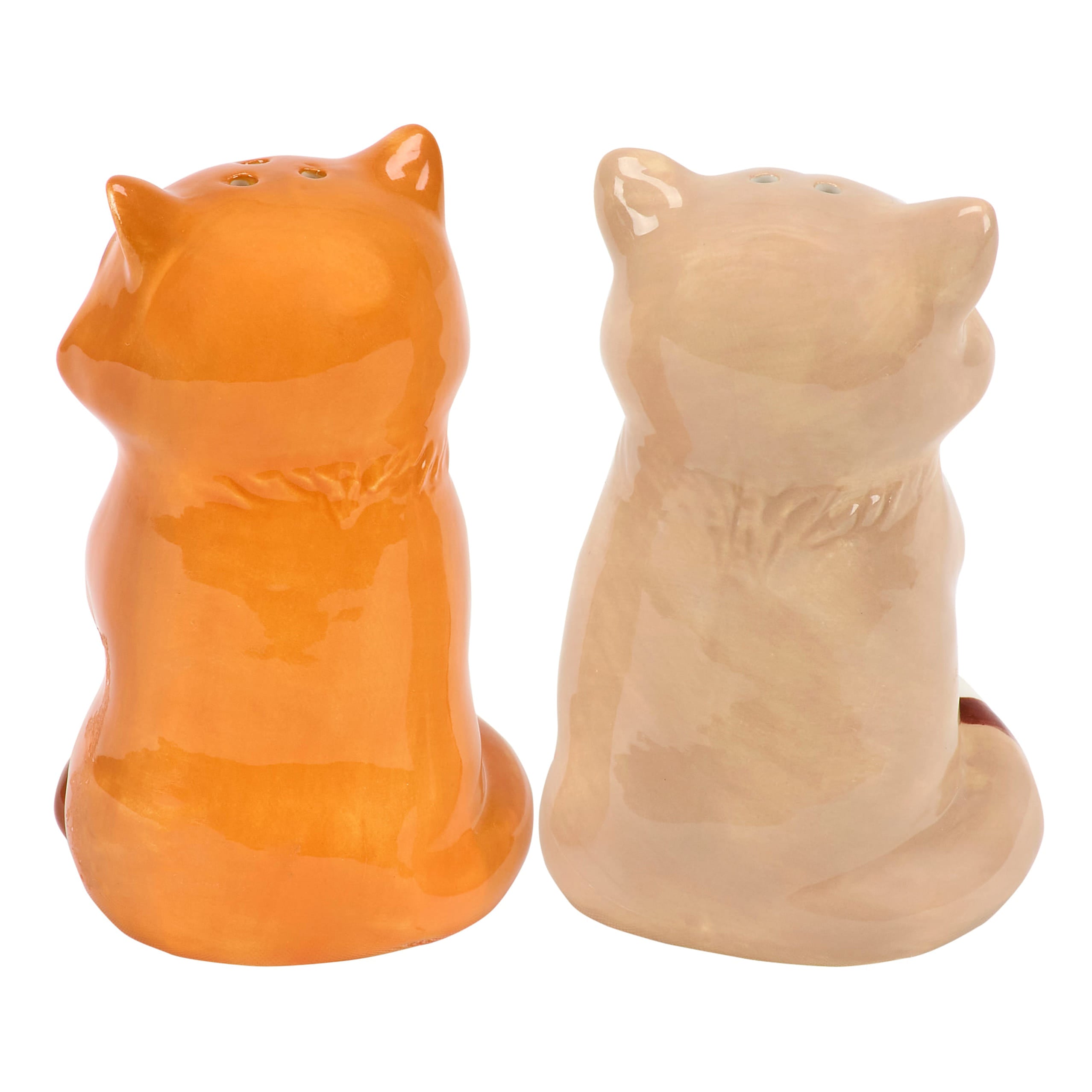 A pair of ceramic salt & pepper shakers shaped like sitting foxes in vibrant orange and soft beige from forest friends