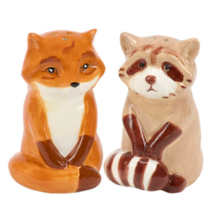 Ceramic salt and pepper shakers shaped like a fox and raccoon with painted orange and tan fur for halloween ghost figures fans