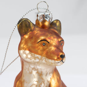 A translucent fox glass ornament with amber white marbled finish and black eyes nose, vintage-inspired finish perfect for heart ornaments